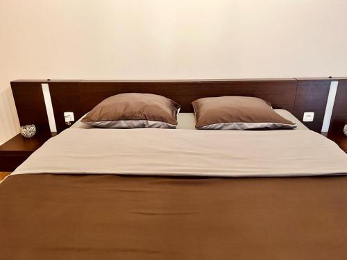 a large bed with two pillows on top of it at R&M in Kortessem