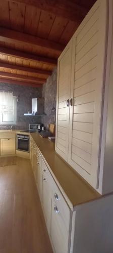 a kitchen with white cabinets and a counter top at Holiday Home in Sfendouri, Aegina in Sfendoúrion