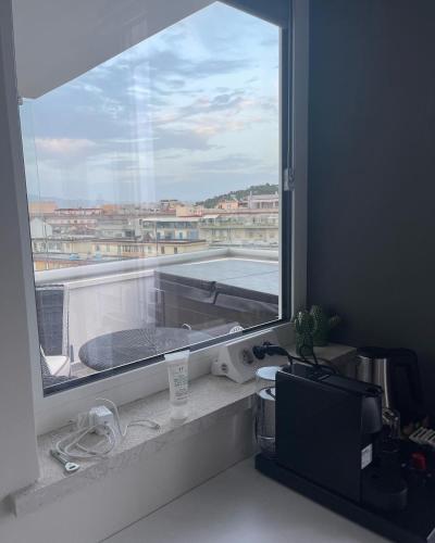 a window in a room with a view of a balcony at 18 Dante Luxury Suites in Cagliari
