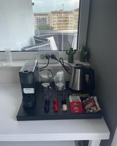 a black shelf with a coffee maker and a window at 18 Dante Luxury Suites in Cagliari