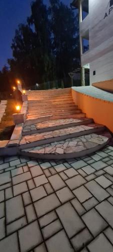 a set of stairs leading up to a building at night at RA Apartmani Vrdnik in Vrdnik