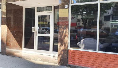 a reflection of a car in the window of a store at Hotel AATRAC Buenos Aires in Buenos Aires
