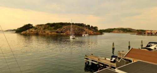 a boat is docked at a dock in the water at Marinan Richters in Fjällbacka