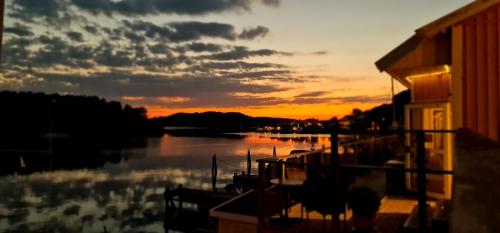 a sunset over a body of water with a building at Marinan Richters in Fjällbacka