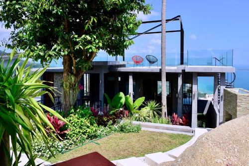 a house with a basketball hoop on top of it at Paradise Villa Elysium - Sea View Infinity Pool with Waterfall & Jacuzzi in Koh Samui 