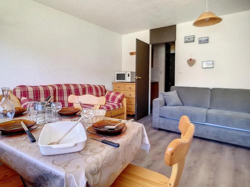 un salon avec une table et un canapé dans l'établissement Studio cosy au coeur de la station - Balcon sud/ouest - Accès direct aux pistes - FR-1-344-992, aux Menuires