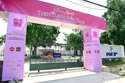 a gate with a pink sign in front of a gate at Hotel Grand United - Ahlone Branch in Yangon