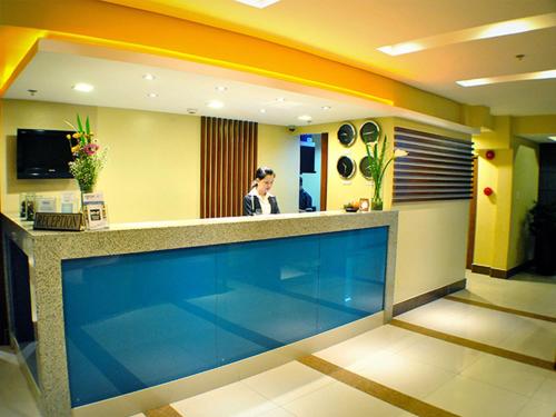 a woman standing at a reception counter in a hospital at Fersal Hotel Kalayaan, Quezon City in Manila