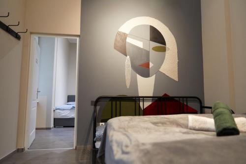 a bedroom with a mask on the wall at Beautiful View Duna Apartment in Budapest