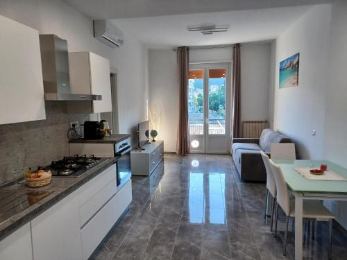 a kitchen and living room with a couch and a table at Adelina House in La Spezia