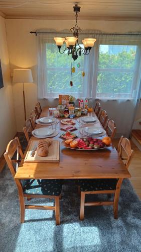 a wooden table with a plate of fruit on it at Bubbles Breakfast and Spa in Sandefjord