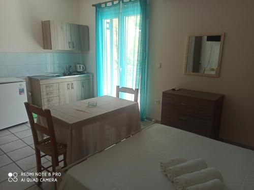 a kitchen with a table with two chairs and a dining room at Erminia Studios in Mousata