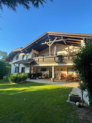 a large house with a patio and a yard at Haus zum Glück in Reifnitz