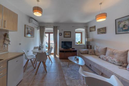ein Wohnzimmer mit einem Sofa und einem Tisch in der Unterkunft Apartments Franovic in Perast