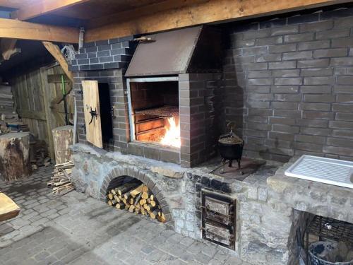 a large brick oven with a fire in it at Apartament Pod Górką Gołdap in Gołdap