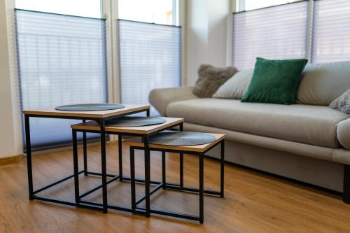 two tables in a living room with a couch at Apartament No 34 Green - Holiday Home Zator in Zator