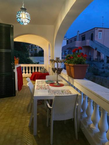 a white table and chairs on a balcony at villa martina suite apartament in Lacco Ameno