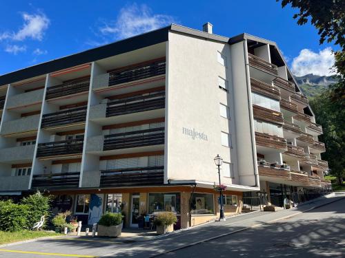 a building with a sign on the side of it at Apartmenthaus Majesta in Leukerbad