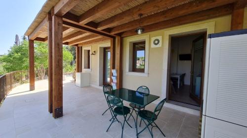 a patio with a table and chairs on a porch at Casa vacanze Le Agavi in Modica