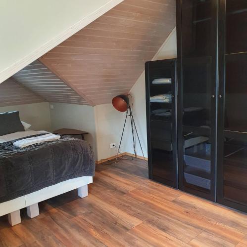 a bedroom with a bed and a wooden ceiling at E18 Apartments in Akureyri