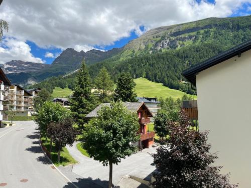a view of a village with mountains in the background at Residenz Majesta in Leukerbad