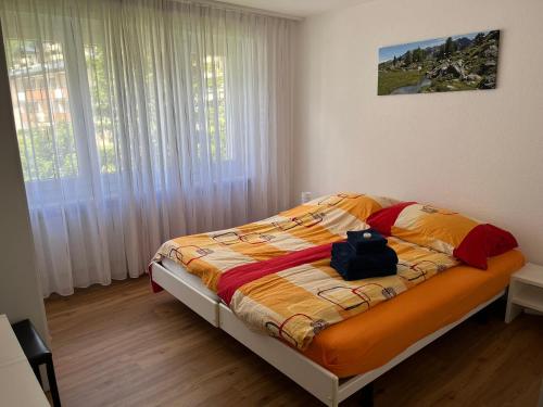 a bedroom with a bed with a backpack on it at Residenz Majesta in Leukerbad