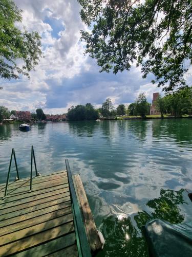a view of a lake with a wooden dock at Apartament Nova Kamienica 1 in Łagów