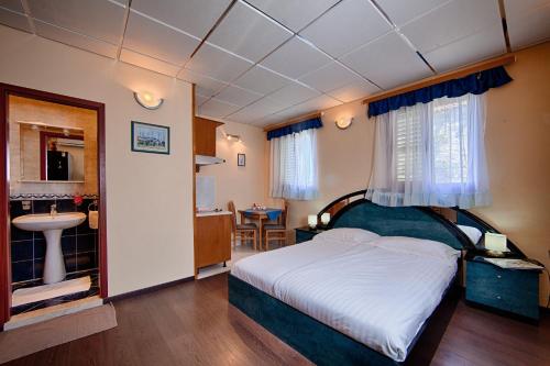 a bedroom with a bed and a bathroom with a sink at Nautic Studio A4 in Vis
