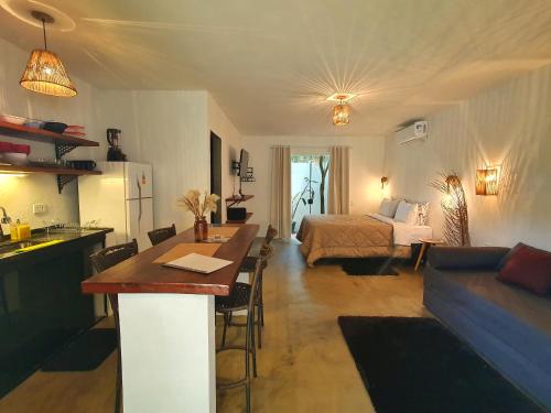 a living room with a kitchen and a bedroom with a bed at Morada dos Saguis in Alto Paraíso de Goiás
