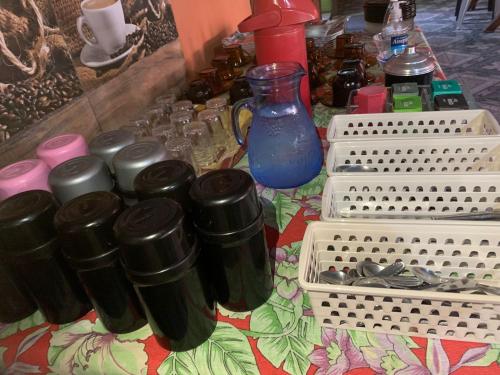 a table topped with bottles and containers on a table at Pousada e Restaurante Tio Paulo in Teresópolis