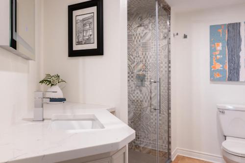 a bathroom with a sink and a shower at Retro Suites Hotel in Chatham