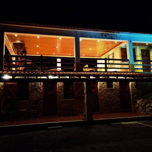 a building with a balcony at night at Quinta do Vale Encantado "the Valley" - Santarém - Portugal in Calhariz