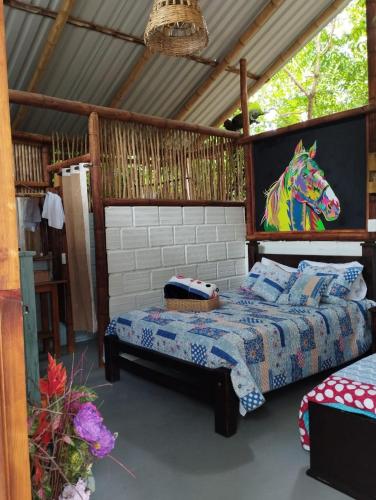 a bedroom with a bed with a horse head on it at Finca Ecoturistica LOS JAGUEYES in Baraya