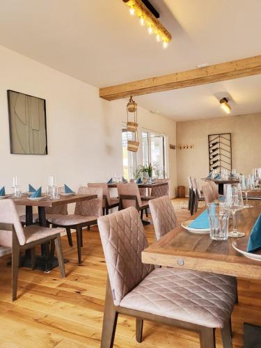 a dining room with wooden tables and chairs at Boutique Hotel Marielle in Bad Münstereifel