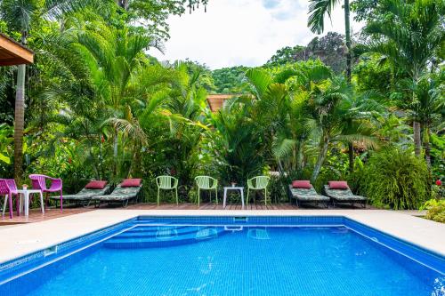 a swimming pool with chairs and a resort at La Paz del Caribe Adults Only in Puerto Viejo