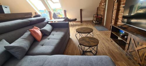 a living room with a couch and two tables at Apartments Nähe Red Bull Ring in Proleb