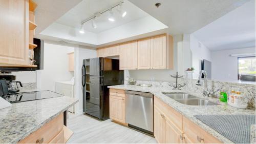 a kitchen with wooden cabinets and stainless steel appliances at Excellent location,Relax in the heart of the City!! by Kivoya in Phoenix