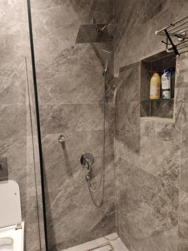 a shower in a bathroom with a glass door at شاليه فاخر جداً جداً وخاص in Riyadh