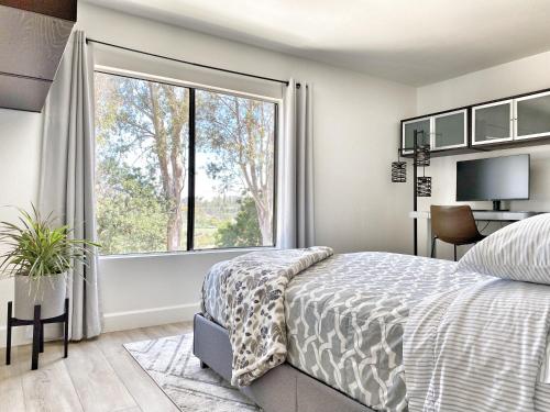 a bedroom with a bed and a large window at OCLuxeBnB Private Resort Living Minutes from Beach in Laguna Hills