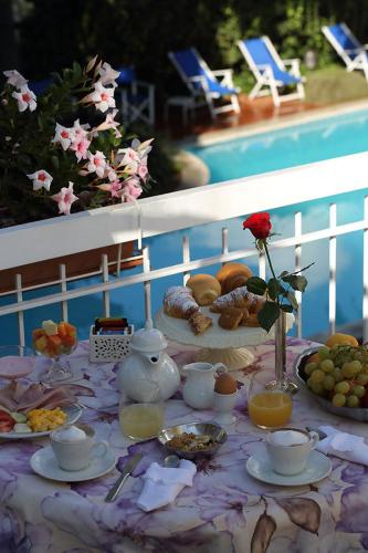 a table with breakfast foods and drinks on it at Hotel Bergamo Mare Mhotelsgroup in San Bartolomeo al Mare