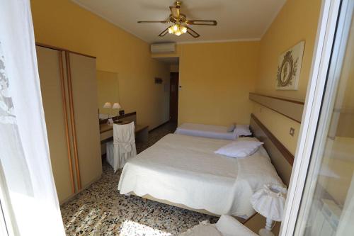 a bedroom with a bed and a ceiling fan at Hotel Bergamo Mare Mhotelsgroup in San Bartolomeo al Mare