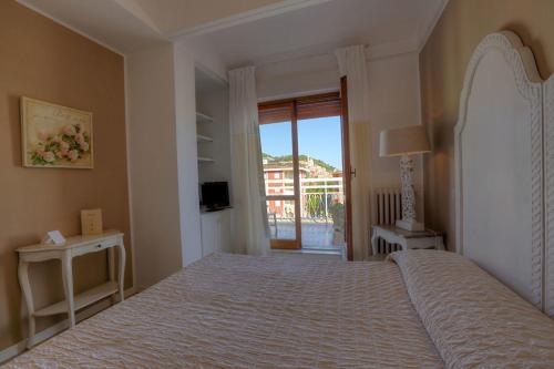 a bedroom with a large bed and a balcony at Hotel Bergamo Mare Mhotelsgroup in San Bartolomeo al Mare