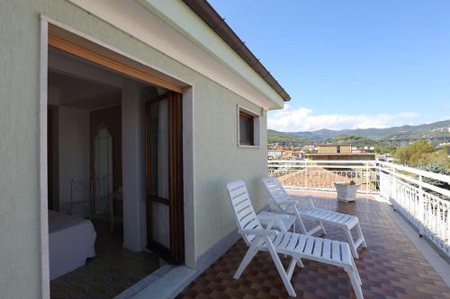 two white chairs sitting on the balcony of a house at Hotel Bergamo Mare Mhotelsgroup in San Bartolomeo al Mare