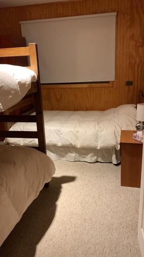 a room with two bunk beds and a projection screen at HOTEL BOUTIQUE ANTTUY - Snow Spa in Chillán