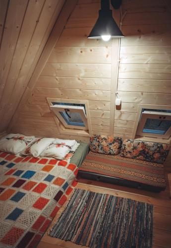 a bedroom with a bed in a wooden room at Dziewięćsił Blisko ziemi Góry Stołowe Duszniki Zdrój in Lewin Kłodzki