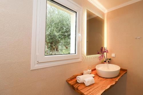 a bathroom with a sink and a window at Elizabeth Country House - 3BR spacious villa in Vragkaniótika