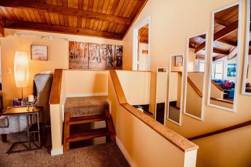 a room with a staircase leading up to a house at Exposed Beam 3BR Modern Mountain Retreat in Thornton