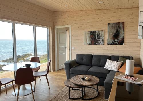 a living room with a couch and a table at Eyri Seaside Houses in Hvammstangi
