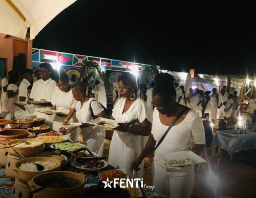 a group of women standing around a buffet of food at Fenti Nubian Resort in Aswan