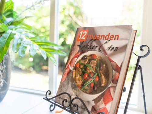 a magazine sitting on a table next to a plant at Villa Lucia in Rucphen